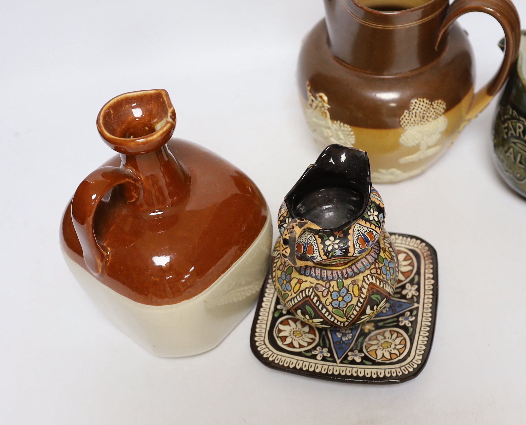 Three Thoune glazed earthenware items comprising dish, jug and vase, two signed to the base, the largest 12cm wide, Two Doulton stoneware jugs and a Long John whisky ewer, largest 17cm high